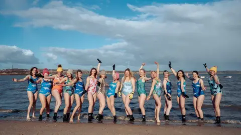 TazzyBro photography Some of the Manningtree Mermaids group on a beach