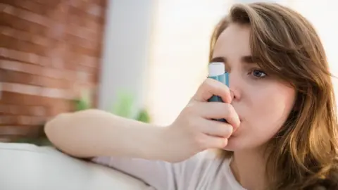 Getty Images Young woman with an inhaler