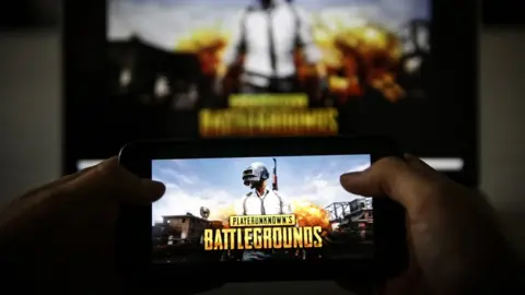 Getty Images A man plays PUBG game on smartphone in Ankara, Turkey on November 26, 2018