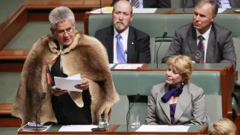 Getty Images/Fairfax Media Ken Wyatt, wearing a traditional kangaroo skin coat, delivers his maiden speech in parliament