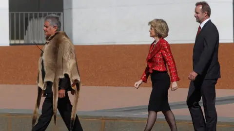 Getty Images/ Fairfax Media Ken Wyatt wearing a traditional Indigenous kangaroo skin coat walks in front of Liberal MPs Julie Bishop and Nigel Scullion outside parliament house in 2010