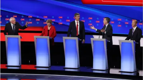 Getty Images Democratic presidential candidate Sen. Bernie Sanders (I-VT) (L) and former Colorado governor John Hickenlooper (2nd R) speaks while Sen. Elizabeth Warren (D-MA) (2nd L), former Texas congressman Beto O'Rourke and former Maryland congressman John Delaney during the Democratic Presidential Debate