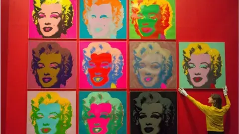 Getty Images A member of the British Museum staff makes a final adjustments to a selection of ten colour Andy Warhol screen prints featuring Marilyn Monroe in February 10, 2017