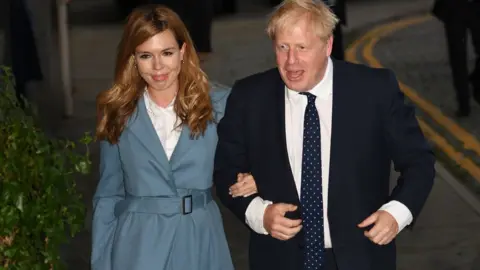 Getty Images Boris Johnson and his partner Carrie Symonds arrive in Manchester