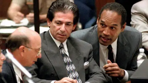 Getty Images Robert Kardashian (centre) helped defend OJ Simpson