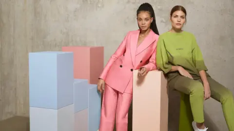 ZALANDO Two models wear Zalando products, a pink and green suit