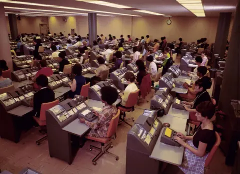 Getty Images Women at work in the book-keeping room at the Bank of America, Los Angeles circa 1970