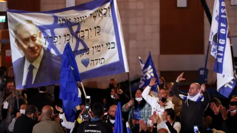 Reuters Supporters of Israeli Prime Minister Benjamin Netanyahu's Likud party react following the release of exit polls for the general election on 23 March 2021