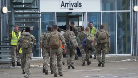 PA Media Armed forces return