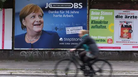 Getty Images A recruitment agency billboard marks Angela Merkel's time in office