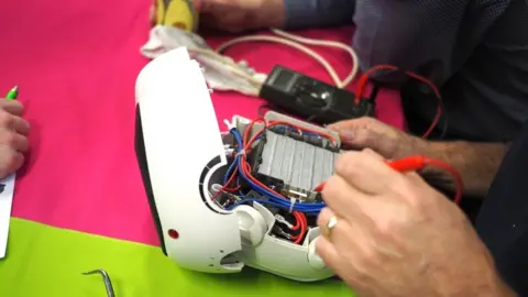 Gary Buller A sewing machine being repaired