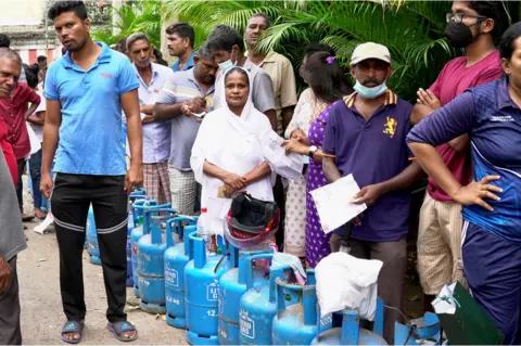 BBC/Tessa Wong People wait to fill gas cylinders in Slave Island, Colombo, 11 July 2022