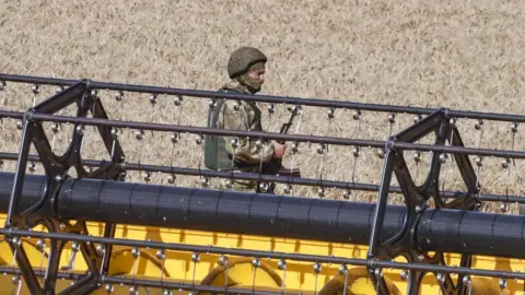 EPA Russian soldier in a field in Ukraine