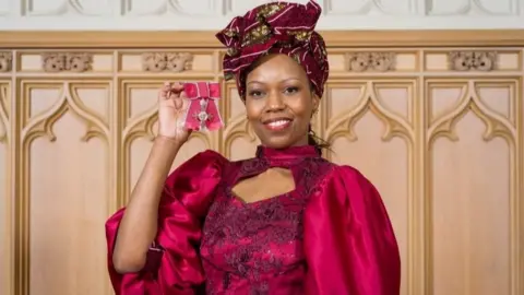 Cornwall Partnership NHS Foundation Trust Charity Gladstone holding her MBE