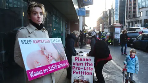 Getty Images An anti-abortion activist outside the Marie Stopes Clinic on January 12, 2016 in Belfast, Northern Ireland.