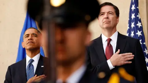 Reuters President Barack Obama and new FBI Director James Comey place their hands over their hearts during an installation ceremony for Comey at FBI Headquarters in Washington on 28 October, 2013.