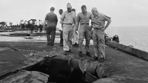 Getty Images John McCain (r) surveying the damage to the USS Forrestal