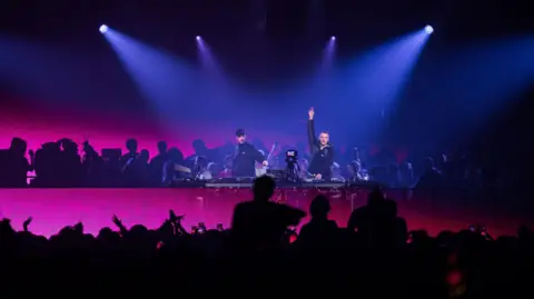 Plaster A dj performing to a crowd