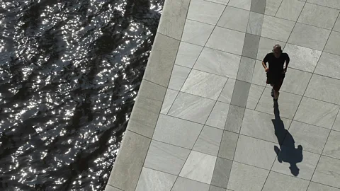 Getty Images A jogger runs along the Spree river near the Bundestag in Berlin, Germany (Credit: Getty Images)
