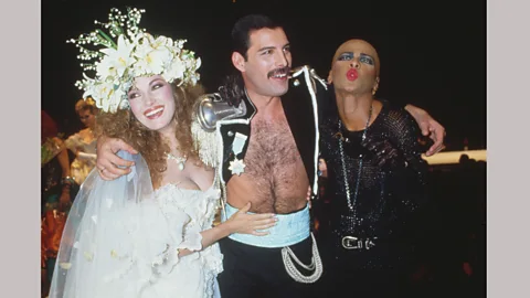 Getty Images Jane Seymour in an Emanuel gown, with Freddie Mercury and friend at a Fashion Aid benefit in 1985 (Credit: Getty Images)