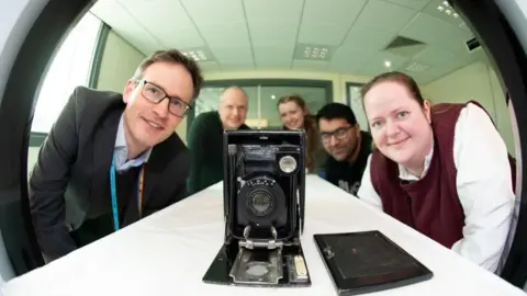 PA Media University and museum staff looking at the camera in the scanner