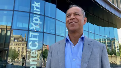 BBC PwC's chairman for the North Armoghan Mohammed standing outside the new One City Park offices