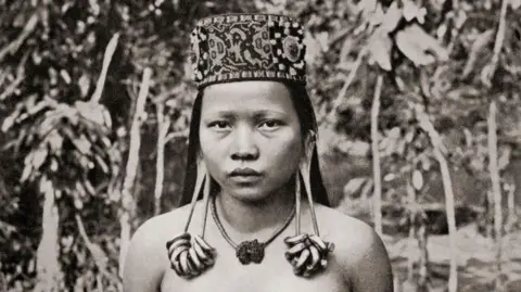 Getty Images A Kenyah woman from Sarawak, Borneo, Malaysia, with distended ear lobes. After a 19th century photograph.