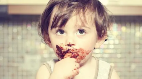Getty Images Baby eating chocolate