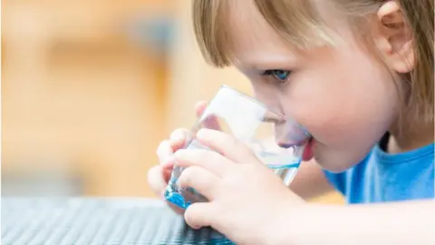 Getty Images Child drinking water
