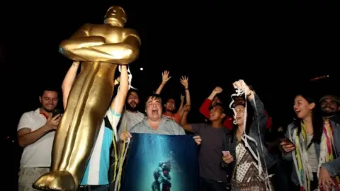AFP Fans of Mexican director Guillermo del Toro celebrate at La Minerva square, in Guadalajara, Jalisco State, on March 4, 2018, after del Toro won the Oscar for "The Shape of Water."