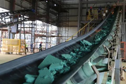 AFP/Getty A conveyor belt carries chunks of Raw cobalt after a first transformation at a plant in Lubumbashi on February 16, 2018, before being exported, mainly to China, to be refined.