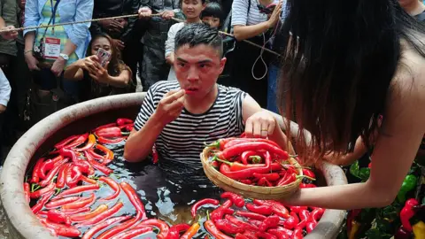 Getty Images A contestant takes part in a chilli pepper-eating competition in China