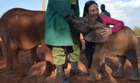 AFP Hong Kong lawmaker Elizabeth Quat (R) poses with a juvenile elephant as she visits the David Sheldricks orphan elephant foundation in the Kenyan capital, Nairobi, on September 13, 2014.