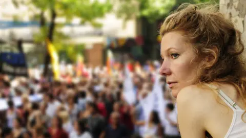 Getty Images A woman watches a demonstration