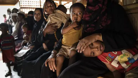 Getty Images Children sit on laps in Cox's bazaar camp