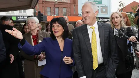 Getty Images Julia Banks and Malcolm Turnbull walk and gesture in front of reporters