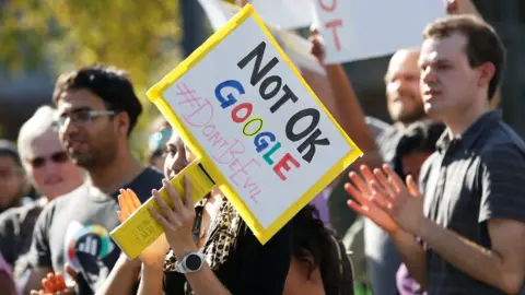 Reuters A Google employee (centre) holds a sign that reads "Not OK Google" during a walkout in Mountain View, California
