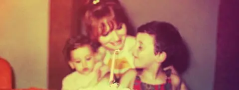 Getty Images A vintage looking image recreation of a mother and her children on the daughter's first birthday