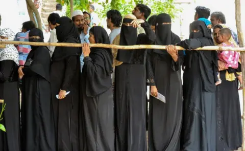 Getty Images Indian Muslim women stand in a queue to cast their vote at a polling station in Kurnool district of the Indian state of Andhra Pradesh, on April 11, 2019.