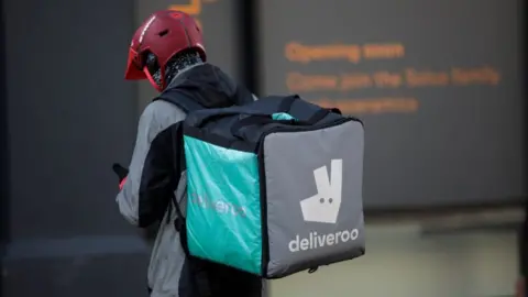 Getty Images A Deliveroo rider making a delivery in London.