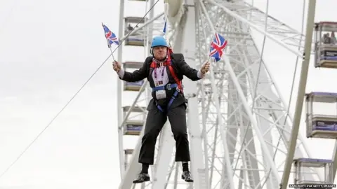 Barcroft via Getty Images Boris Johnson hanging on a zip wire in 2012