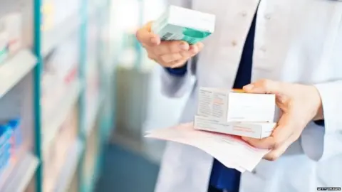 Getty Images Pharmacist holding medicines