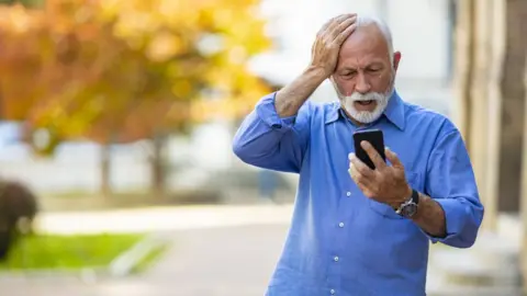Getty Images Old man surprised by phone