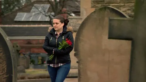 Charlotte Butcher visiting her husband's grave