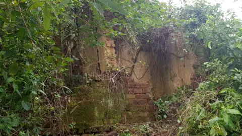 BBC/Patience Atuhaire  Remains of one of the buildings