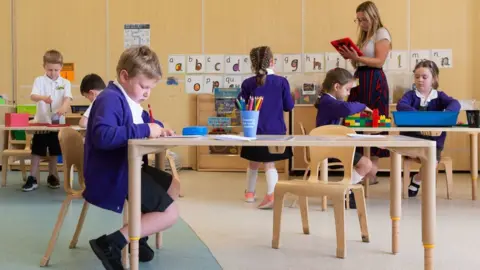 PA Media Children socially distanced in a classroom after returning to school following coronavirus closures