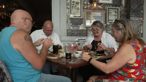 Diners at the Spyglass and Kettle pub
