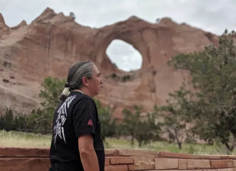 Mark Charles Campaign Mark Charles pictured with the landmark Window Rock in the background