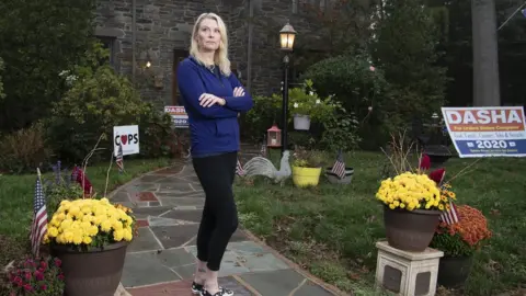 Jose Moreno Dasha Pruett, a candidate for Congress and a Trump supporter, standing in front of her house