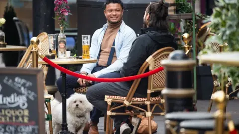 Getty Images People enjoying a drink in Cardiff